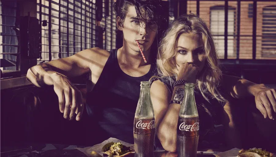 A girl and a man in a Coke AD